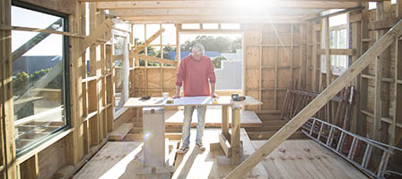 Builder working on a wood framed house